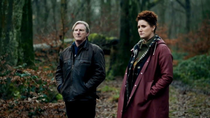 A man and a woman stand in a forest in Ridley.