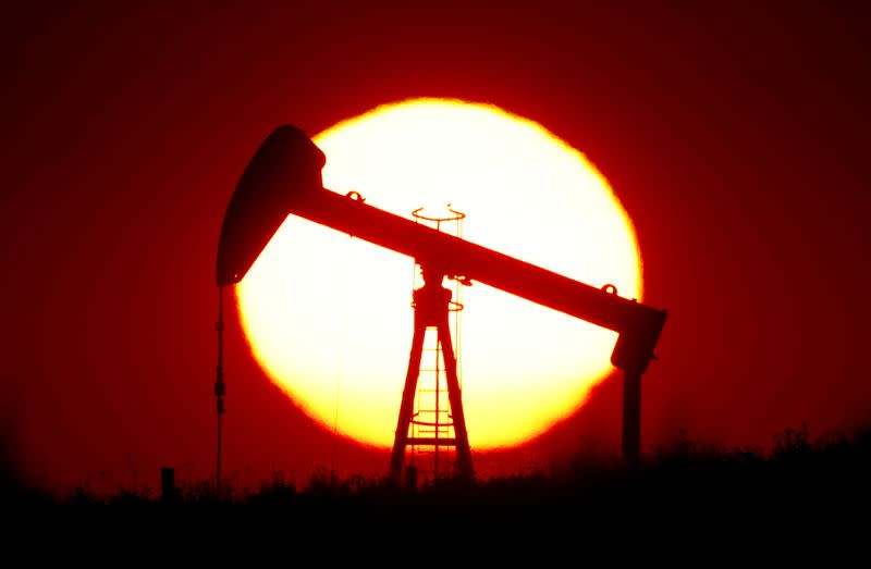 FILE PHOTO: The sun sets behind a pump-jack outside Saint-Fiacre