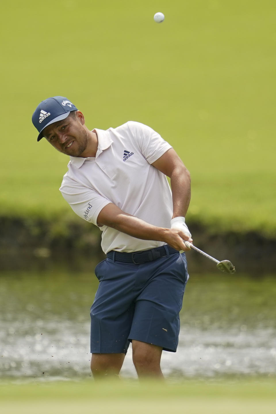 Xander Schauffele chips to the green on the 13th hole during a practice round for the PGA Championship golf tournament, Tuesday, May 17, 2022, in Tulsa, Okla. (AP Photo/Sue Ogrocki)