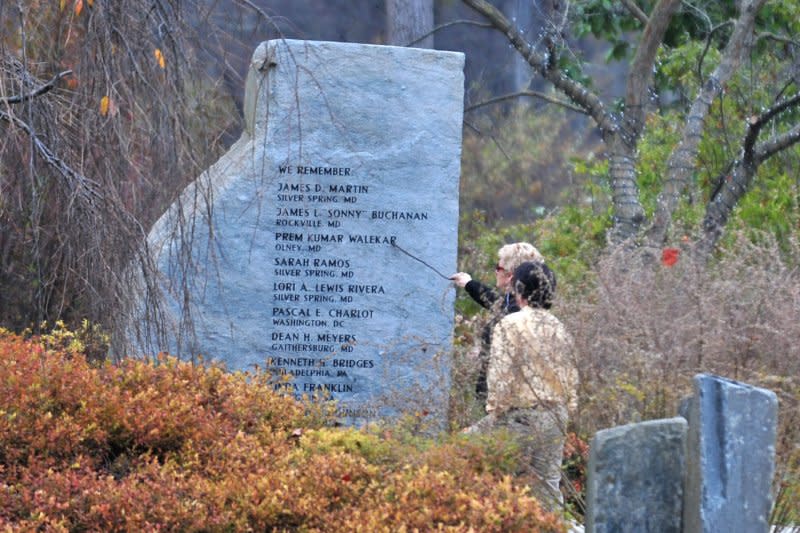 People visit the D.C. sniper victims' memorial, dedicated to the victims of the 2002 D.C. Sniper shootings, at Brookside Gardens in Wheaton, Md., on November 10, 2009. On October 3, 2002, a 55-year-old Maryland man was slain in the first in a series of apparent random sniper attacks that terrorized the Washington area for three weeks. File Photo by Kevin Dietsch/UPI