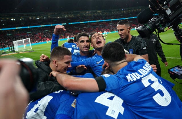 Greece celebrate scoring the winning goal against England at Wembley