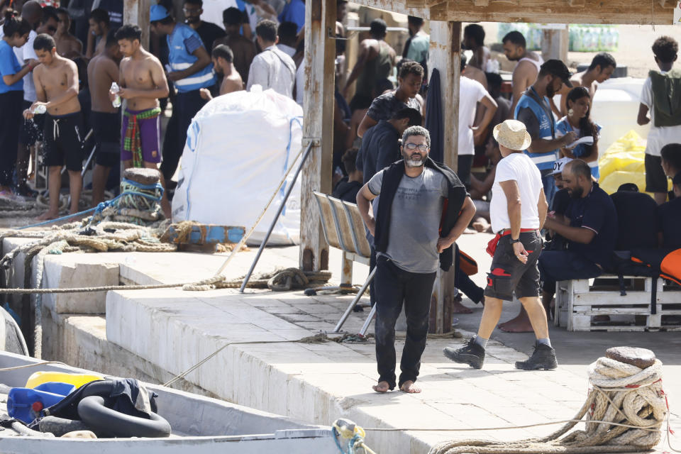 Migrants stand on the dock of the port of the Sicilian island of Lampedusa, southern Italy, Monday, Sept. 18, 2023, a day after European Commission President Ursula von der Leyen visited the island, overwhelmed with thousands of migrants arrivals the past week. (Cecilia Fabiano/LaPresse via AP)