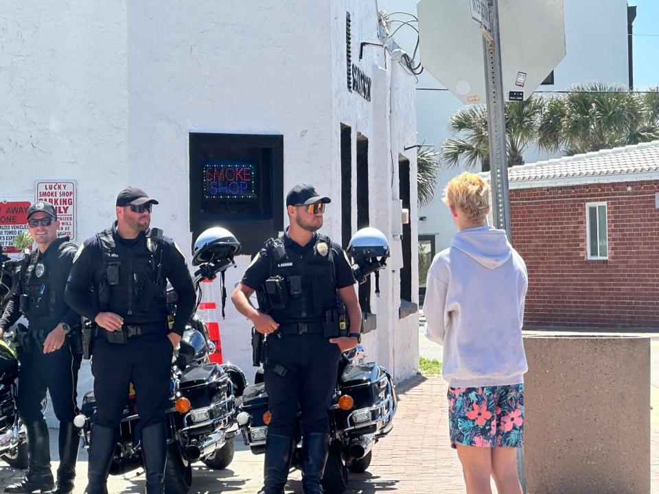 Police officers stationed along Flagler Avenue during spring break week in New Smyrna Beach, Tuesday, March 19, 2023.
