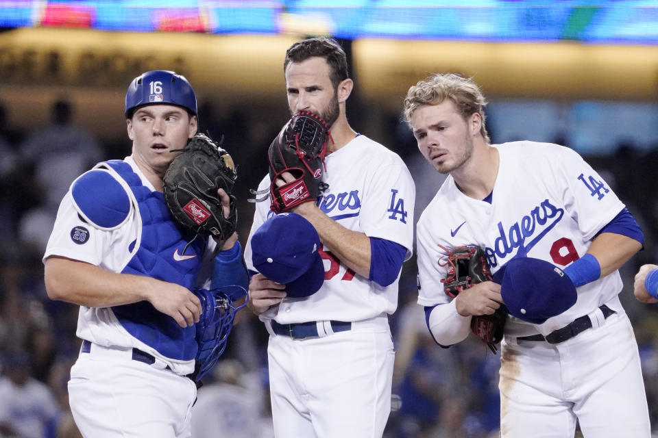 Los Angeles Dodgers catcher Will Smith, left, Los Angeles Dodgers' Jake Reed, center, and shortstop baseman Gavin Lux chat as Reed comes in to pitch during the ninth inning of a baseball game against the Arizona Diamondbacks Friday, July 9, 2021, in Los Angeles. (AP Photo/Mark J. Terrill)