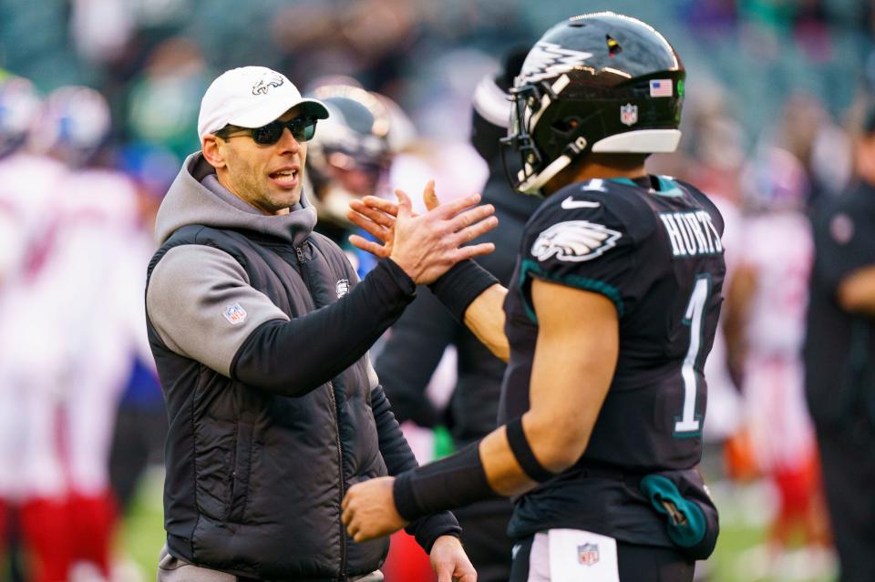 Philadelphia Eagles defensive coordinator Jonathan Gannon, left, reacts to quarterback Jalen Hurts (1) prior to the NFL football game against the New York Giants, Sunday, Jan. 8, 2023, in Philadelphia.