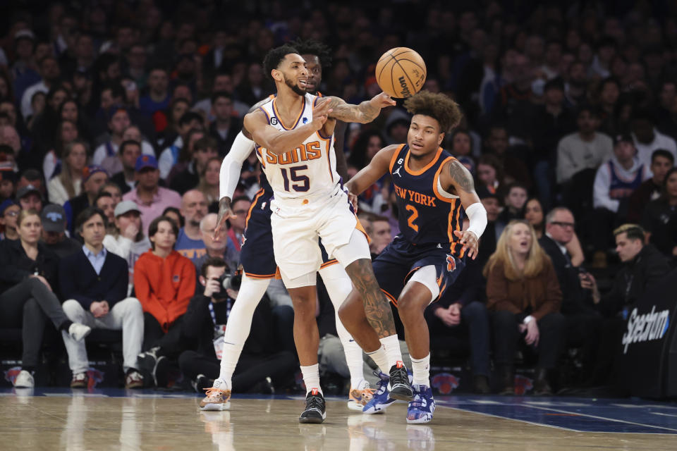 Phoenix Suns guard Cameron Payne (15) passes the ball as Phoenix Suns forward Josh Okogie (2) looks on during the first half of an NBA basketball game, Monday, Jan. 2, 2023, in New York. (AP Photo/Jessie Alcheh)