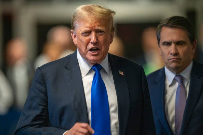 Donald Trump speaks while wearing a suit and tie