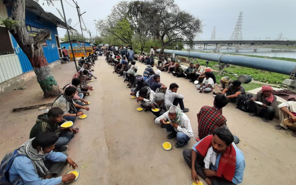 Homeless and impoverished Indians receive food at a government shelter in New Delhi, India, Thursday, March 26, 2020. Some of India's legions of poor and people suddenly thrown out of work by a nationwide stay-at-home order began receiving aid distribution Thursday, as both the public and private sector work to blunt the impact of efforts to curb the coronavirus pandemic. (AP Photo)