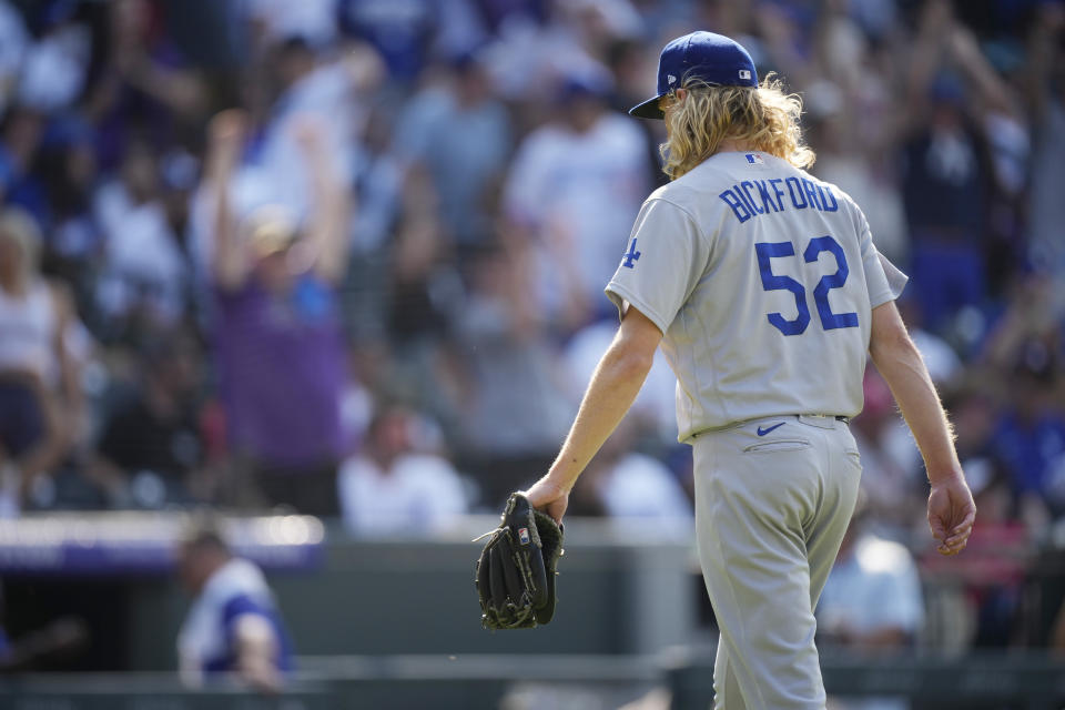 Los Angeles Dodgers relief pitcher Phil Bickford heads to the dugout after giving up a solo walkoff home run to Colorado Rockies' Charlie Blackmon in the 10th inning of a baseball game Sunday, July 18, 2021, in Denver. (AP Photo/David Zalubowski)