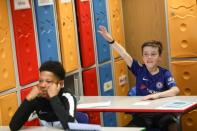 A year 6 child puts his hand up to answer during class at St Dunstan's College junior school as some schools re-open following the outbreak of the coronavirus disease (COVID-19) in London