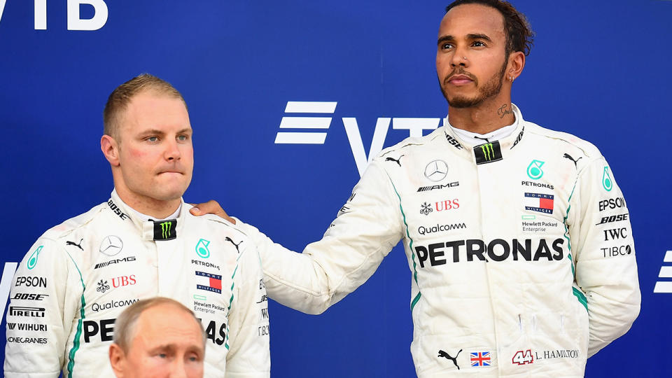 Lewis Hamilton and Valtteri Bottas share on awkward moment on the podium. (Photo by Clive Mason/Getty Images)