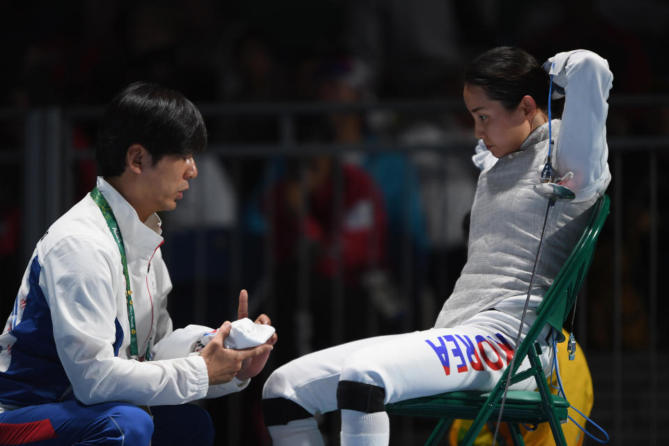 RIO DE JANEIRO, BRAZIL - AUGUST 10:  Hyunhee Nam of Korea talks to her trainer during the women's individual foil on Day 5 of the Rio 2016 Olympic Games at Carioca Arena 3 on August 10, 2016 in Rio de Janeiro, Brazil.  (Photo by Matthias Hangst/Getty Images)