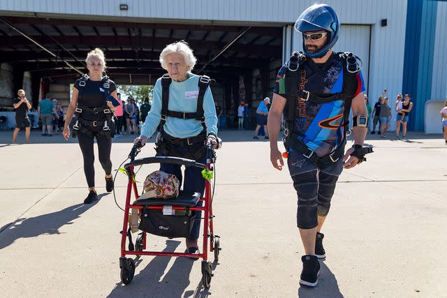 <p>Brian Cassella/Chicago Tribune/Tribune News Service via Getty</p> This photo shows skydiver Dorothy Hoffner, 104, pushing her walker out to the plane with tandem jumper Derek Baxter. Hoffner set a world record on Oct. 1, 2023 for being the oldest person to skydive. She died a week later on Oct. 9.