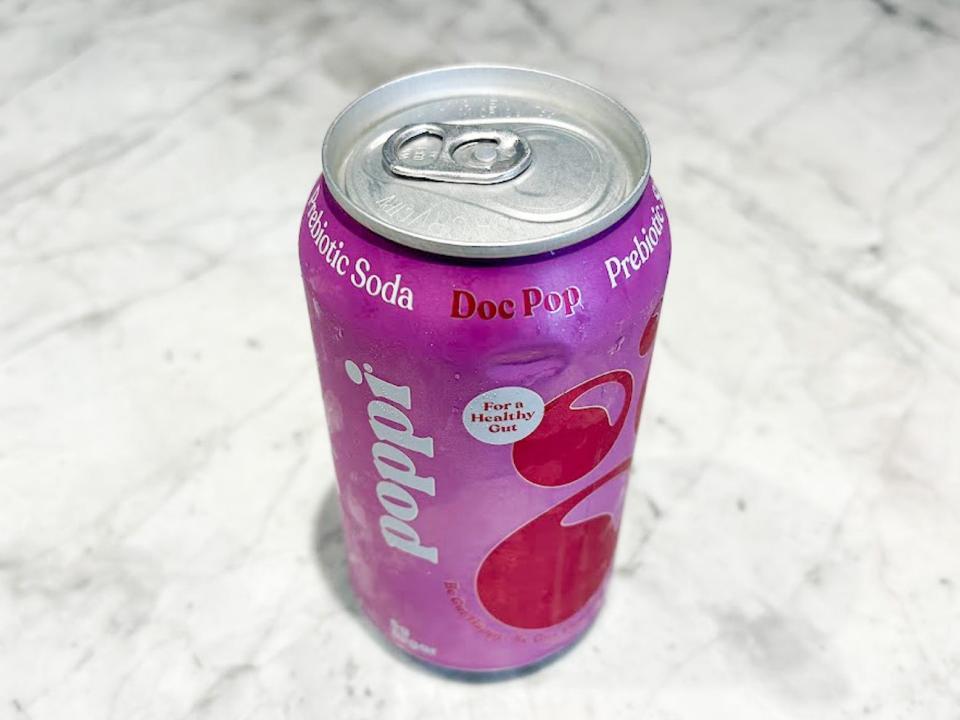 An unopened can of Poppi doc pop on a countertop.
