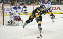 Pittsburgh Penguins' Jake Guentzel (59) chases down the puck in front of New York Rangers goaltender Igor Shesterkin (31) during the second period of an NHL hockey game, Saturday, Feb. 26, 2022, in Pittsburgh. (AP Photo/Keith Srakocic)