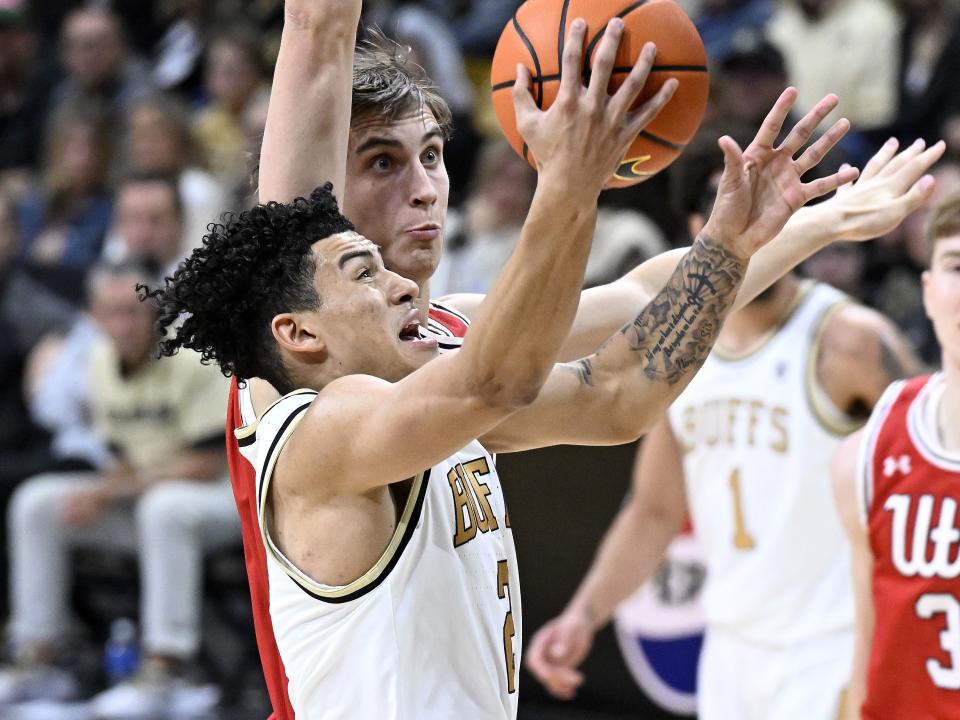 Colorado guard KJ Simpson, front, drives to the basket past Utah forward Jake Wahlin, top, in the second half of an NCAA college basketball game Saturday, Feb. 24, 2024, in Boulder, Colo. | Cliff Grassmick, Associated Press