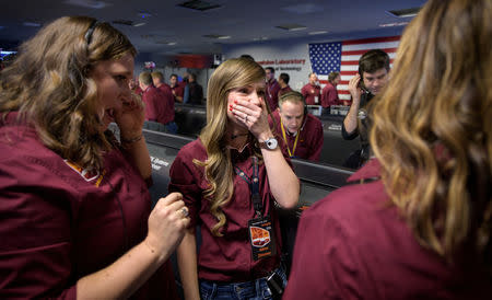NASA JPL engineers Julie Wertz-Chen (L), and Aline Zimmer, (C), react after receiving confirmation that the Mars InSight lander successfully touched down on the surface of Mars, at NASA's Jet Propulsion Laboratory in Pasadena, California, U.S., November 26, 2018 NASA/Bill Ingalls/Handout via REUTERS 