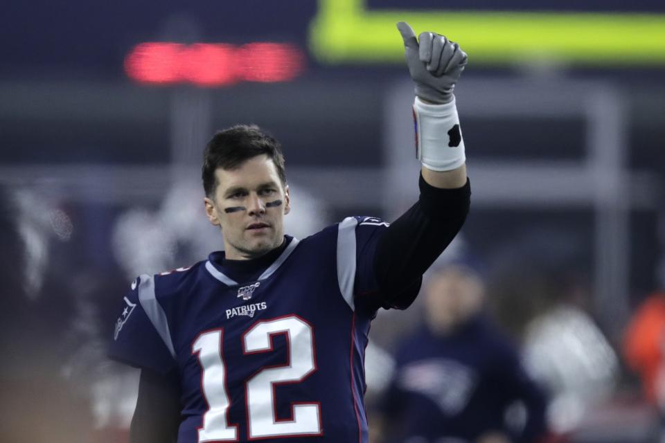 FILE - In this Jan. 4, 2020, file photo, New England Patriots quarterback Tom Brady gestures to a teammate before an NFL wild-card playoff football game against the Tennessee Titans in Foxborough, Mass. A highlight of the opening weekend of the NFL season will have Brady's regular-season debut with Tampa Bay against Drew Brees at New Orleans on Sept. 13 — the first matchup of 40-plus quarterbacks in NFL history. (AP Photo/Charles Krupa, File)