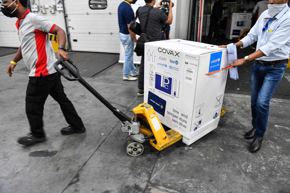 Image: The AstraZeneca vaccine made by the Serum Institute of India is unloaded at Mumbai airport this week as part of the COVAX rollout. (INDRANIL MUKHERJEE / AFP - Getty Images)