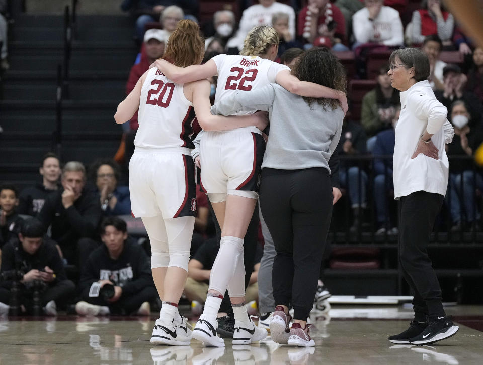 Stanford head coach Tara VanDerveer, right, looks on as Stanford forward Cameron Brink (22) is taken off the court after colliding with an Oregon player during the first half of an NCAA college basketball game Friday, Jan. 19, 2024, in Stanford, Calif. (AP Photo/Tony Avelar)