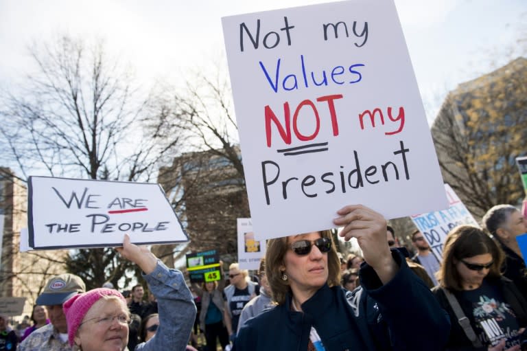 Demonstrators rally in Dupont Circle prior to marching to the White House during a "Not My President Day" protest in Washington, DC, February 20, 2017