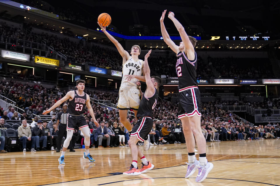 Purdue forward Brian Waddell (11) shoots over Davidson guard Foster Loyer (0) in the first half of an NCAA college basketball game in Indianapolis, Saturday, Dec. 17, 2022. (AP Photo/Michael Conroy)