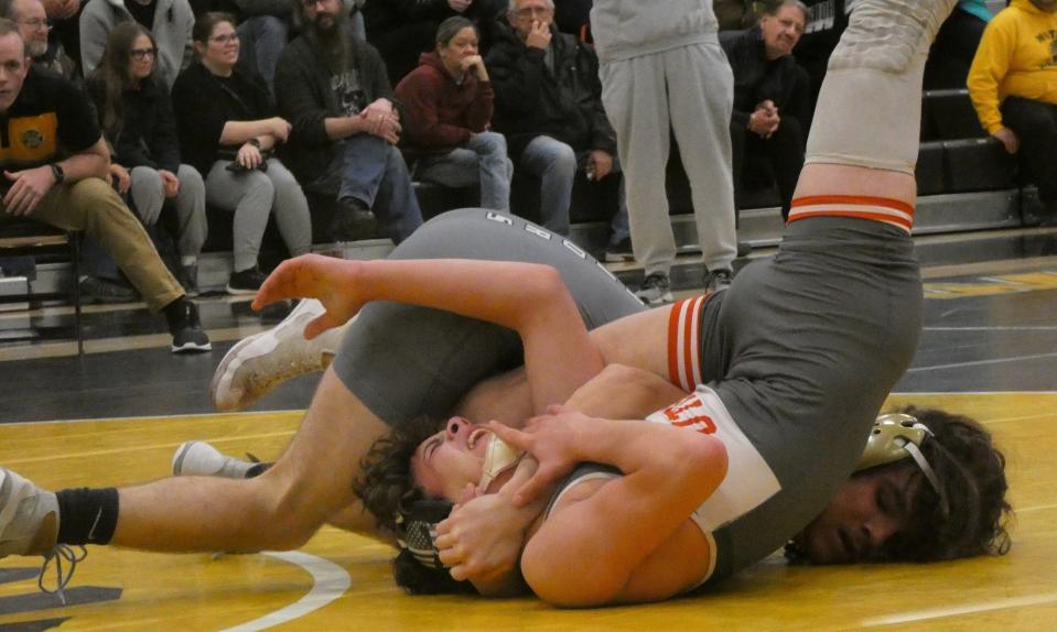 Watkins Memorial junior Jayden VanBalen attempts to pin Utica's Cameron Stemm in a 132-pound match during a season-opening dual on Thursday, Dec. 1, 2022. VanBalen won by pin to help the host Warriors pick up a 55-18 victory.