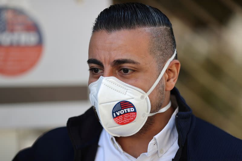 FILE PHOTO: Fabian Garcia wears an “I Voted” sticker on his mask after voting in the U.S. presidential election at Homegirl Cafe during the global outbreak of the coronavirus (COVID-19) disease, in Los Angeles