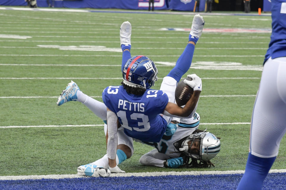 Carolina Panthers' Stantley Thomas-Oliver (23) tackles New York Giants' Dante Pettis (13) at the goal line during the second half of an NFL football game Sunday, Oct. 24, 2021, in East Rutherford, N.J. Pettis scored a touchdown on the play. (AP Photo/Bill Kostroun)