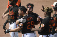 Baltimore Orioles' Ramon Urias (29) and Ryan McKenna, back, and Domingo Leyba (75) celebrate after a baseball game against the Washington Nationals, Sunday, July 25, 2021, in Baltimore. (AP Photo/Nick Wass)