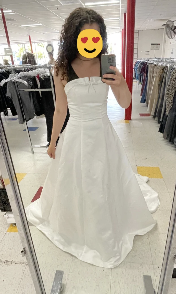 A woman taking a selfie in her wedding dress