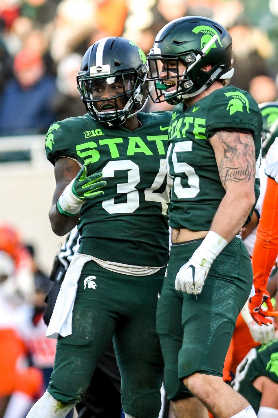 Michigan State's Antjuan Simmons, left, and Noah Harvey celebrate a stop during the first quarter on Saturday, Nov. 9, 2019, at Spartan Stadium in East Lansing.