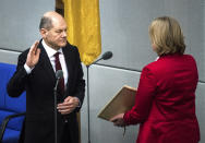 New elected German Chancellor Olaf Scholz is sworn in by parliament President Baerbel Bas in the German Parliament Bundestag in Berlin, Wednesday, Dec. 8, 2021. The election and swearing-in of the new Chancellor and the swearing-in of the federal ministers of the new federal government will take place in the Bundestag on Wednesday. (Photo/Stefanie Loos)