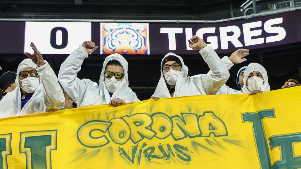 UANL Tigres fans hold a sign while wear hazmat suits and a medical masks during the first half against NYCFC at Red Bull Arena. (Vincent Carchietta-USA TODAY Sports)