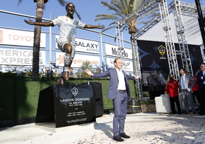 Former Galaxy player Landon Donovan poses with a statue in his likeness at Dignity Health Sports Park