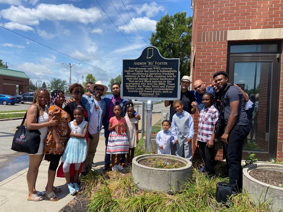 Andrew Foster's children, grandchildren and great grandchildren pose in front of the newly-unveiled historical marker on the property where Foster Hotel used to stand on July 8, 2023.