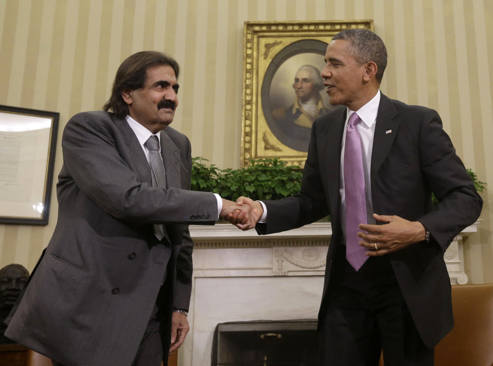 President Barack Obama shakes hands with Sheik Hamad bin Khalifa Al Thani of Qatar during their meeting in the Oval Office of the White House in Washington, Tuesday, April 23, 2013.&nbsp;