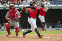 Cleveland Guardians' Jose Ramirez, right, hits a two-run home run off Los Angeles Angels starting pitcher Griffin Canning as Los Angeles Angels' Matt Thaiss watches during the sixth inning of a baseball game in Cleveland, Sunday, May 5, 2024. (AP Photo/Phil Long)