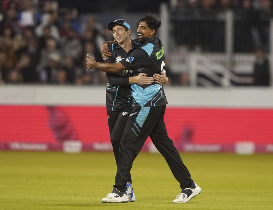 New Zealand's Ish Sodhi, right, celebrates taking the wicket of England's Will Jacks with teammate Mitchell Santner, during the first IT20 cricket match between England and New Zealand, at the Seat Unique Riverside, in County Durham, England, Wednesday, Aug. 30, 2023. (Owen Humphreys/PA via AP)