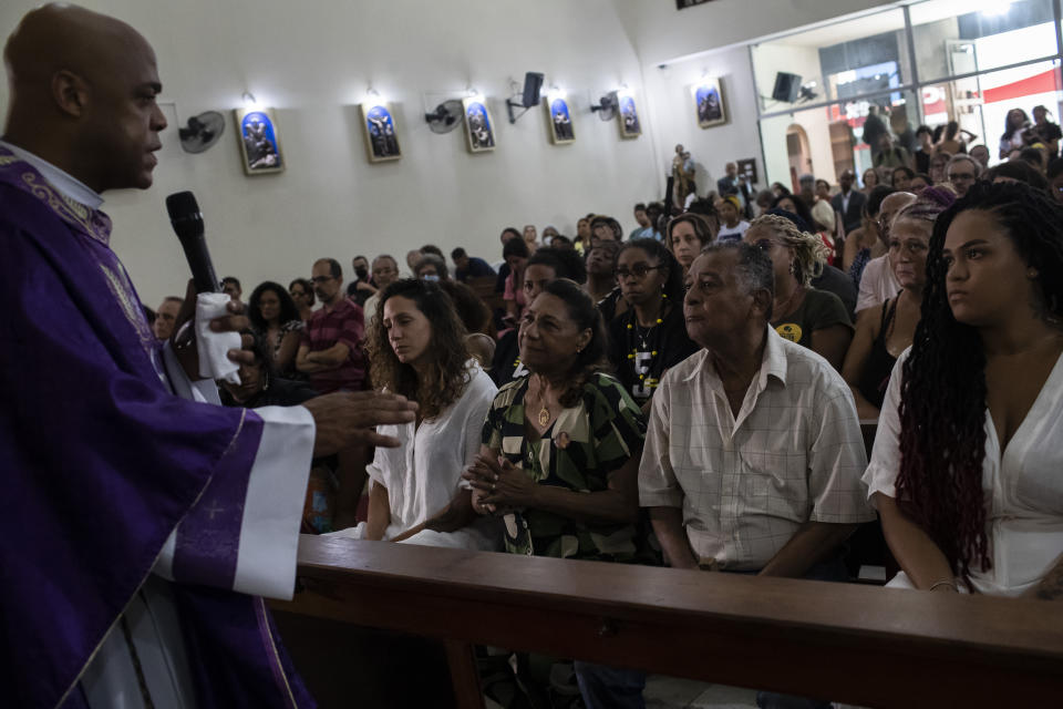 Relatives, friends and supporters of slain councilwoman Marielle Franco and her driver Anderson Gomes attend a Mass marking five years of their deaths, in Rio de Janeiro, Brazil, Tuesday, March 14, 2023. (AP Photo/Bruna Prado)