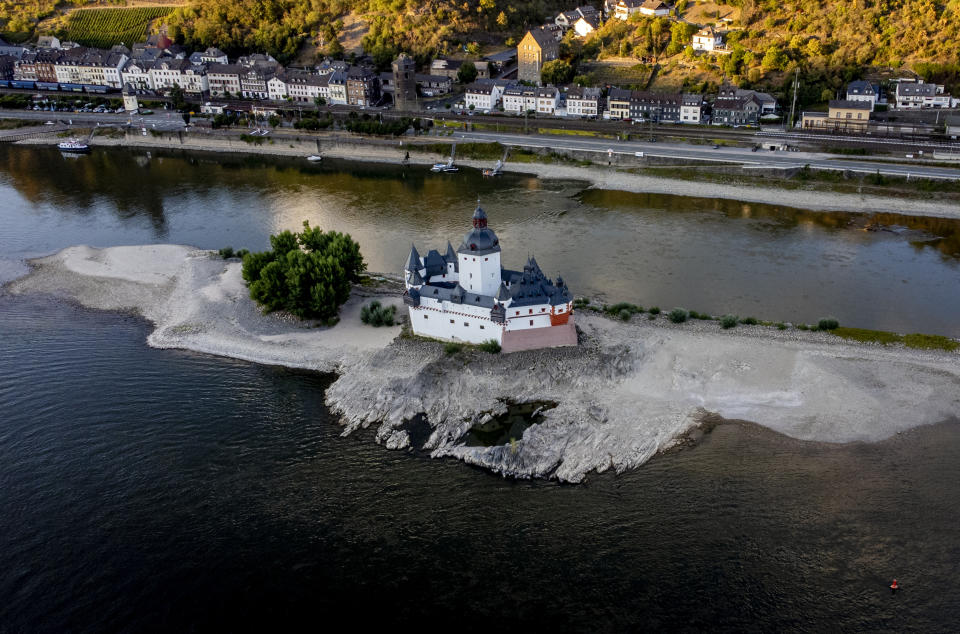 Pfalzgrafenstein castle is pictured in the middle of the river Rhine in Kaub, Germany, Friday, Aug. 12, 2022. The Rhine carries low water after a long drought period. (AP Photo/Michael Probst)