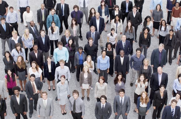 A large group of businesspeople standing, as seen from overhead.