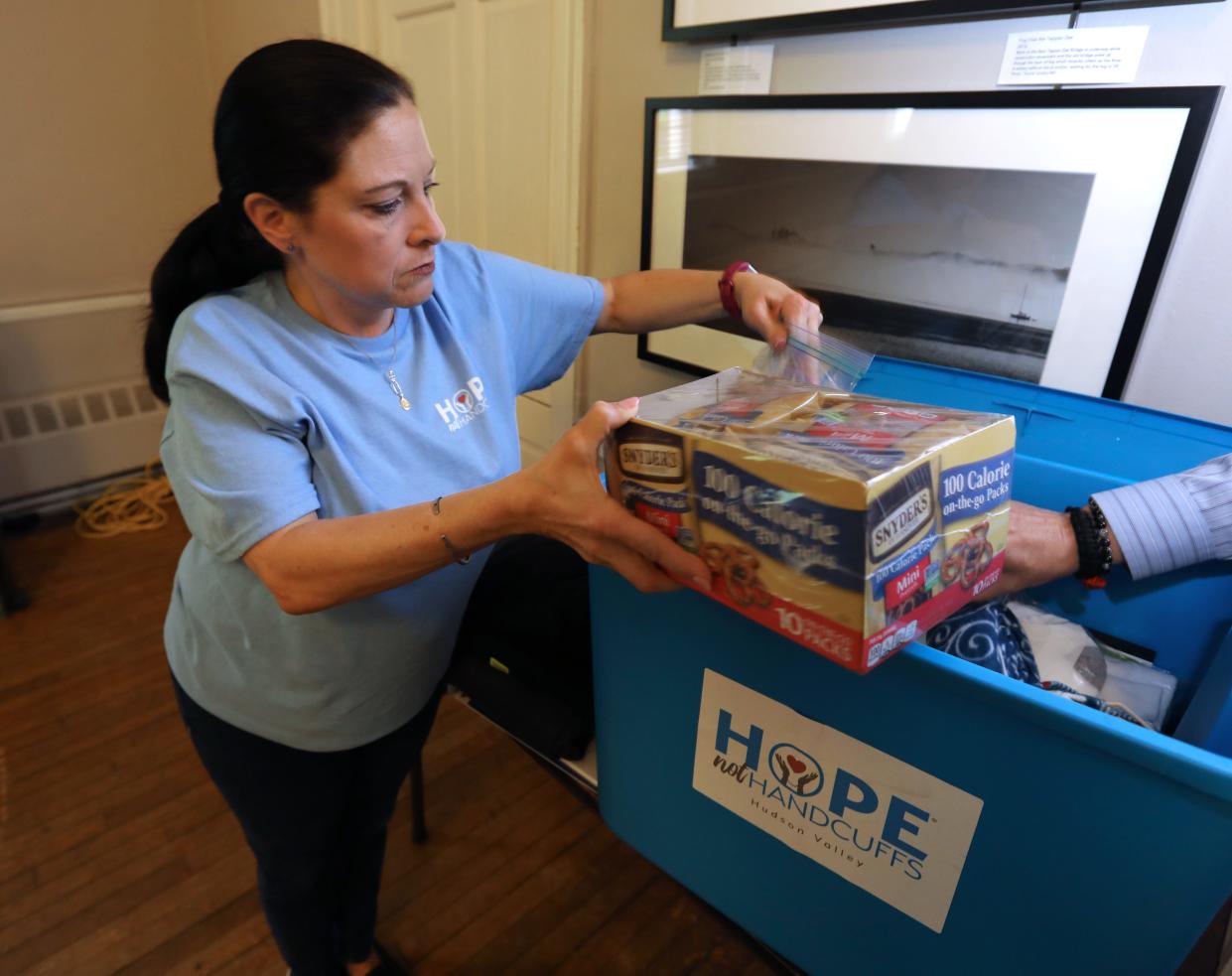 Cathy Kennedy of Congers shows supplies used in the "Hope Not Handcuffs" program that trains police departments to help people seeking opioid addiction treatment May 1, 2019. She is an "angel" volunteer with the program.