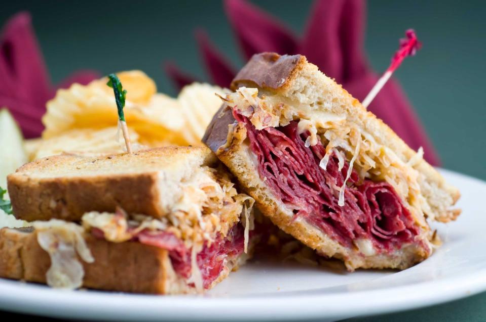 <p><strong>Reuben Sandwich</strong></p><p>While it may not have been invented in Michigan, no one does Reuben Sandwiches like the delis in Detroit -- especially <a href="https://www.zingermansdeli.com/" rel="nofollow noopener" target="_blank" data-ylk="slk:Zingerman's Deli;elm:context_link;itc:0;sec:content-canvas" class="link ">Zingerman's Deli</a>. Thinly sliced corned beef and Swiss cheese, piled high only buttery rye bread, finished off with sauerkraut and Russian dressing. You can’t go wrong grilled or hot-pressed. </p>