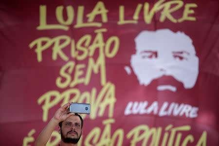 A supporter of imprisoned former Brazil's President Luis Inacio Lula da Silva attends a march before his Workers' Party (PT) officially registers his presidential candidacy, in Brasilia, Brazil, August 15, 2018. REUTERS/Ueslei Marcelino