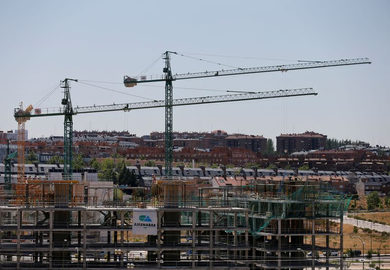 FILE PHOTO: Cranes can be seen at a construction site in north Madrid, Spain