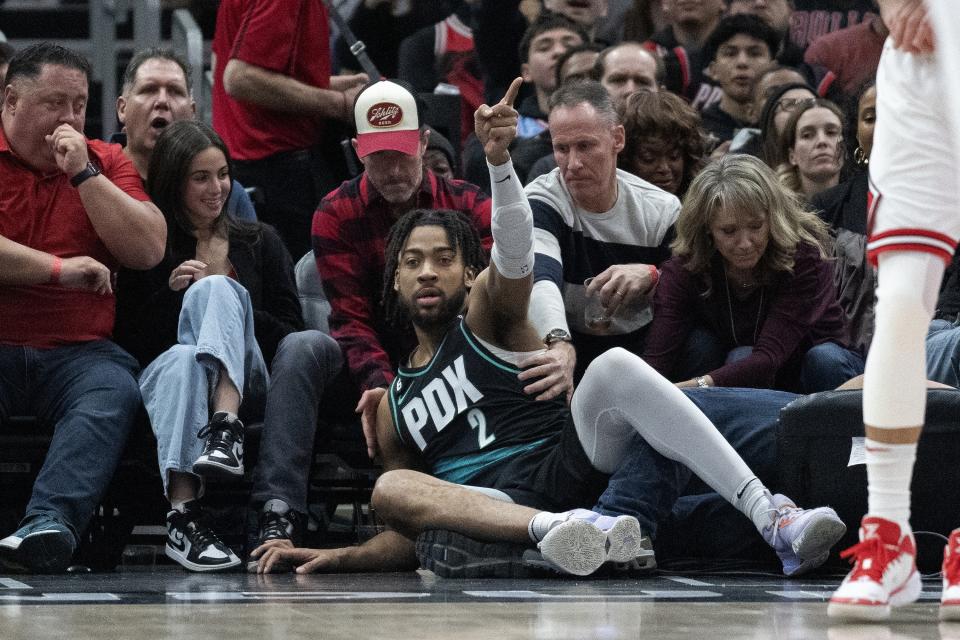 Portland Trail Blazers forward Trendon Watford (2) falls into the crowd during the first half of an NBA basketball game against the Chicago Bulls, Saturday, Feb. 4, 2023, in Chicago. (AP Photo/Erin Hooley)