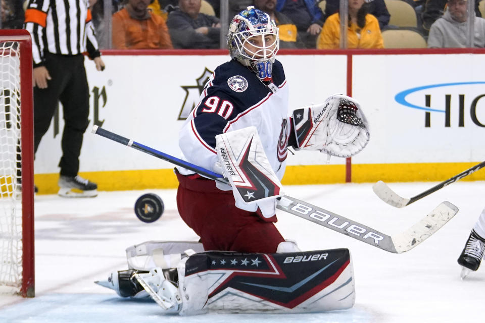Columbus Blue Jackets goaltender Elvis Merzlikins watches the rebounding puck during the second period of an NHL hockey game against the Pittsburgh Penguins in Pittsburgh, Friday, April 29, 2022. (AP Photo/Gene J. Puskar)
