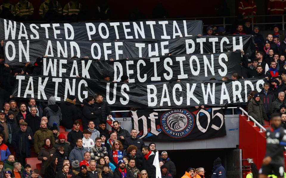 Crystal Palace fans display banners in the stands during the match