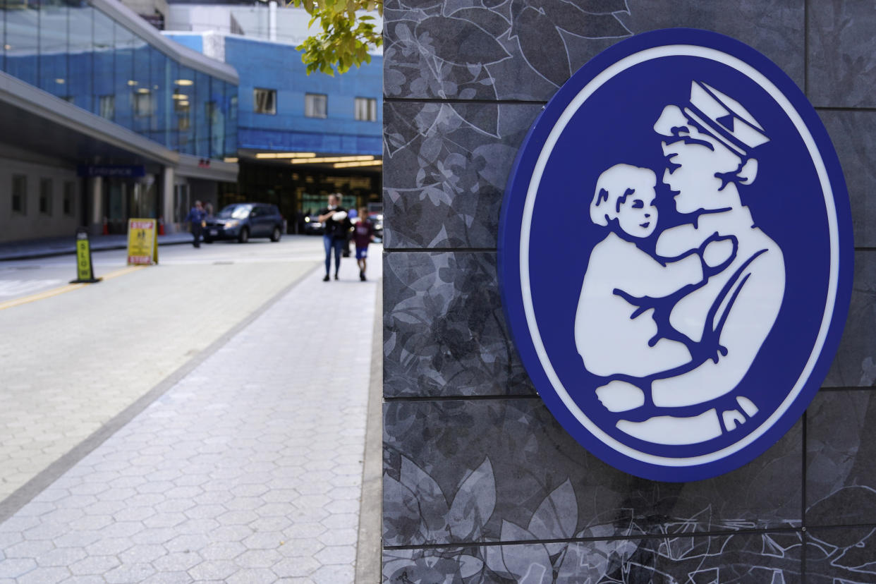 FILE - The logo of a nurse holding a child hangs on a wall outside the Boston Children's Hospital, Aug. 18, 2022, in Boston. (AP Photo/Charles Krupa, File)